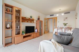 a living room with a couch and a television at Alea Rentals - Maldivas in La Pineda