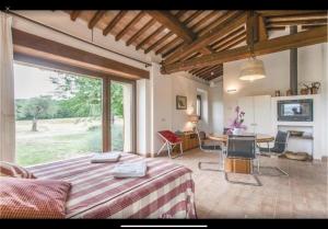a bedroom with a bed and a table and chairs at Casettone di Torre Venturini in Civitella dʼAgliano
