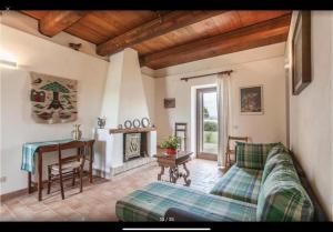 a living room with a couch and a piano at Casettone di Torre Venturini in Civitella dʼAgliano