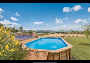 a swimming pool in the middle of a field at Casettone di Torre Venturini in Civitella dʼAgliano
