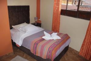 Postel nebo postele na pokoji v ubytování hostal Qorisonqo inn ollantaytambo