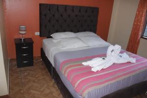 Postel nebo postele na pokoji v ubytování hostal Qorisonqo inn ollantaytambo