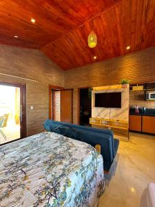 a bedroom with a bed and a flat screen tv at Bem te quero Pipa- apt superior in Pipa
