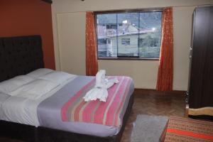 Postel nebo postele na pokoji v ubytování hostal Qorisonqo inn ollantaytambo + 5 fotografií