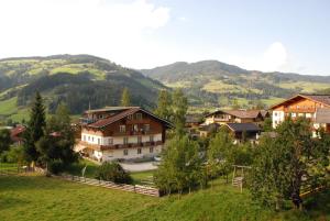 a village in the mountains with houses and trees at Juniorland II in Wagrain