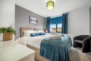 a bedroom with a bed and a chair and a window at Great North Getaways - Newcastle upon Tyne in Jesmond