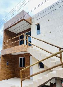 a house with a staircase in front of it at Flat Turmilagres Bontempo in São Miguel dos Milagres