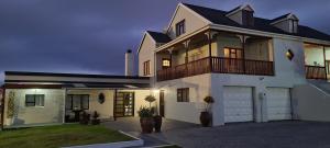 a large white house with a garage at night at 7 on South in Bredasdorp