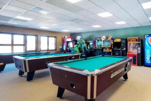 a room with two pool tables and arcade machines at The Inn at Silvercreek 633 in Granby
