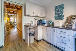 a kitchen with wooden cabinets and a counter top at Wilderness Metanoia in Wilderness