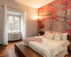 a bedroom with a bed with a painting on the wall at 8 HOME in Rome