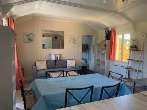 ein Wohnzimmer mit Tisch und Couch in der Unterkunft Cottage les petites voiles plage in Agon Coutainville + 19 Fotos