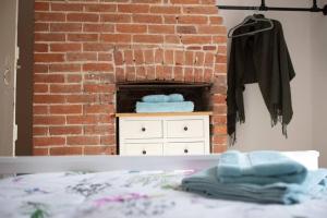 a room with a brick fireplace and a bed at Braybrooke Cottage, Saffron Walden in Saffron Walden