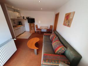 a living room with a couch and a table at Appartementhaus Henghuber in Bad Füssing