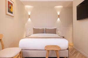 Postel nebo postele na pokoji v ubytování Hôtel Le Daum