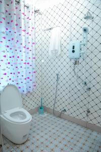 a bathroom with a toilet and a shower at Africa Guest House in Mbarara
