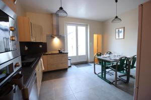 a kitchen with a table and a dining room at L'Ostalada in Albi