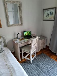 a bedroom with a desk with a computer on it at 7 on South in Bredasdorp