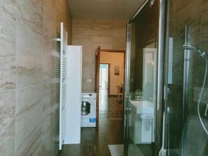 a bathroom with a shower and a washing machine at Appartamento al Centro Storico di San Marino in San Marino