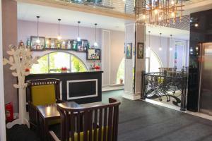 a dining room with a table and chairs and a chandelier at Dondar Hotel Formula 1 View in Baku