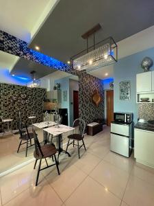 a kitchen and dining room with a table and chairs at The Beacon Residences Condominium in Manila
