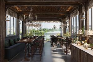 a restaurant with tables and chairs and a view of the water at Hanoi Morning Hotel in Hanoi