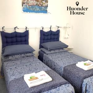 a bedroom with two beds with towels on them at Huonder House in Lecco