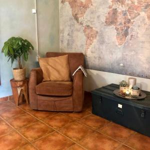 a chair and a table in a room with a map at Lovely quinta in nature with pool - Tomar in Pero Calvo