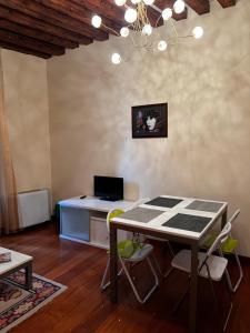 a room with a table with a laptop computer on it at Ormesini Apartment in Venice