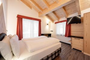 Ein Bett oder Betten in einem Zimmer der Unterkunft Albergo Garni Edy (B&B)