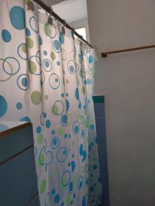 a shower curtain with a polka dot pattern in a bathroom at A Jewel of A Chalet in Roseau