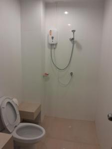 a bathroom with a toilet and a shower stall at Rawai Sea Beach in Phuket Town