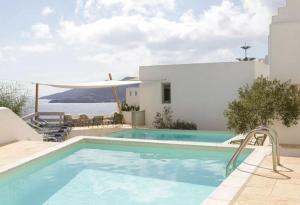 a swimming pool with a view of the ocean at Pylaia Boutique Hotel & Spa in Astypalaia Town +254 photos