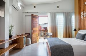 Een bed of bedden in een kamer bij Villa Nautica Boutique Hotel