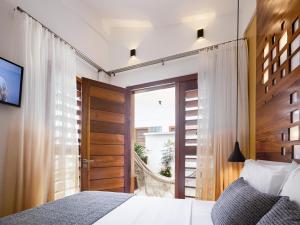 Een bed of bedden in een kamer bij Villa Nautica Boutique Hotel