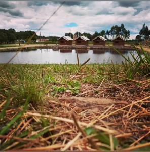 a view of a lake with houses in the background at Pousada Refúgio do Sol in Cambará