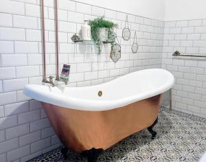 y baño con bañera y azulejos blancos. en Sunset Vista Apartment B en Mação