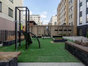 a park with a playground with a swing at 2ndhomes Tampere Brand New "Station" Apartment with Sauna in Tampere