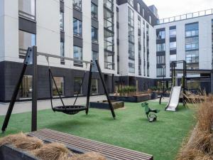 an empty playground with swings in a building at 2ndhomes Tampere Brand New "Station" Apartment with Sauna in Tampere