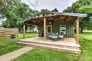 a green cabin with a deck and a grill at Lake Pepin Cottage with Patio - Walk to the Marina! in Pepin