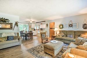 a living room with couches and a dining room at Higgins Lake Getaway with Fire Pit, Walk to Beach! in Roscommon