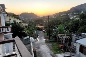 a view of a street with the sunset in the background at Casa Arturo in Mount Gay