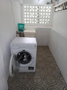 a washing machine in a small room with a window at Casa Arturo in Mount Gay