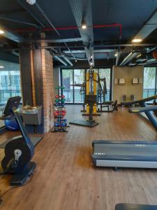 a gym with treadmills and exercise equipment in a room at Lindo Flat Luxuoso em Moema Ibirapuera - Apto 1320 in Sao Paulo