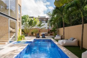 a swimming pool in the backyard of a house at Tulum Private Modern Villa-Pool Beds-AC-Internet-Parking-Grill in Tulum