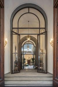 an entrance to a building with an archway at Luxury Apartments by Palazzo Portinari Salviati in Florence