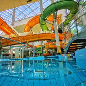 a water slide in a swimming pool at Family Apartman in Gyula