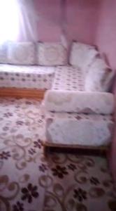 a living room with a couch and a table at location nuit pour les familles in Settat