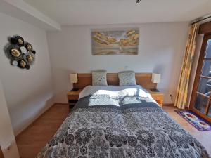 a bedroom with a bed with a black and white comforter at Villa Sonnenblick in Kurort Rathen