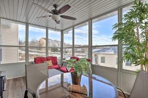 a dining room with a ceiling fan and a glass table at Family-Friendly Branson Condo with Resort Perks! in Branson